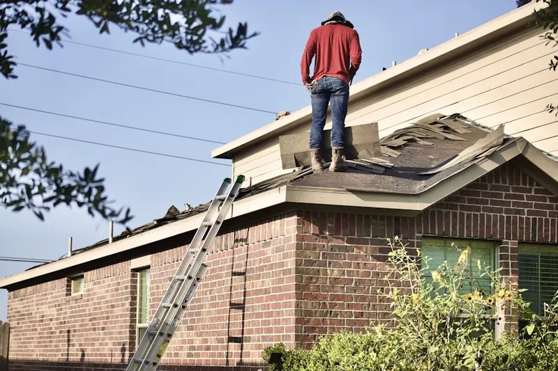 Professional roofer working on a residential roof in Dupont Center